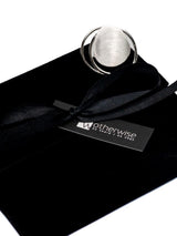 Adjustable Sterling Circle Ring displayed on a black suede pouch, showcasing a large, brushed silver, irregular circle design.