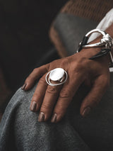 Adjustable Sterling Circle Ring displayed on a hand, featuring a large, abstract, irregular silver circle and an adjustable band.
