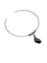 Metallic cylindrical component with black ends on a white background