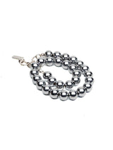 Unisex hematite beaded wrap bracelet featuring 12mm dark gray beads and sleek silver accents, designed for stackable layering.