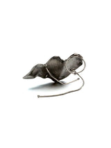 Chunky sculptural ring in irregular textured folded metal, showcasing a unique, avant-garde design in zinc alloy.