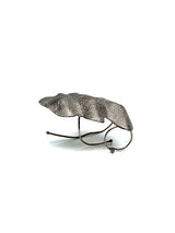 Chunky, irregular knuckle ring in textured zinc alloy with sculptural folded design and a unique, avant-garde aesthetic.