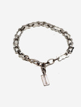 Chunky stainless steel anklet with rectangular links and a small charm, designed for a minimalist, unisex style.