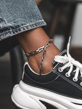 Stainless Steel Rectangular Link Chain Anklet with chunky links, worn with a casual sneaker and denim pants.