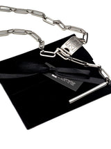 Personalized stainless steel lariat necklace with a Y-drop design and engraved ID bar, placed on a black velvet pouch.